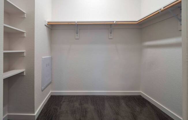 A white wall with a brown shelf and a white door.