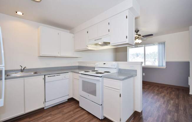 a kitchen with white cabinets and white appliances