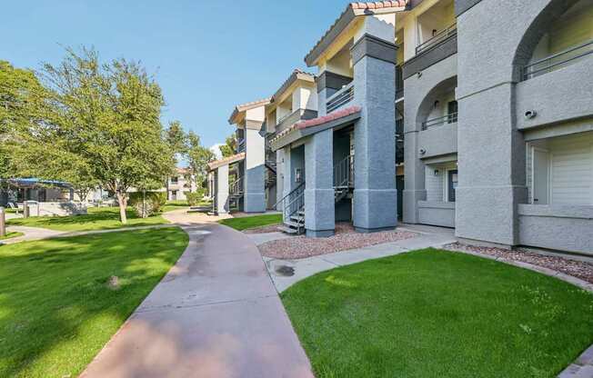 Walkway leading between two rows of apartment buildings.