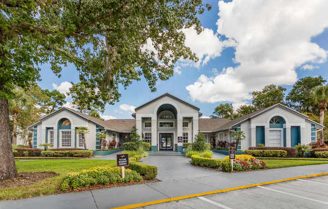 A building with a green lawn in front.