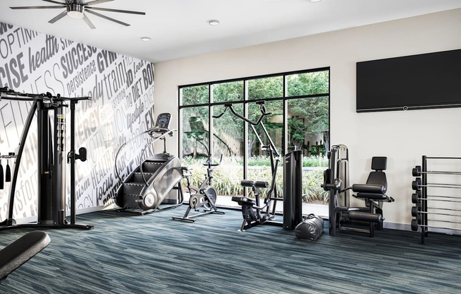 a home gym with exercise equipment and a large window