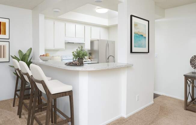 a kitchen with white cabinets and a white counter top