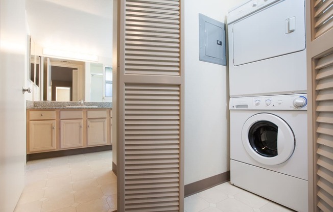 Stackable washer and dryer behind bi-fold doors