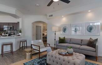 A living room with a grey couch and a coffee table.