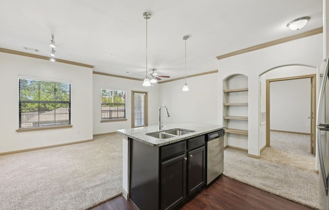 A kitchen with a sink and a refrigerator.