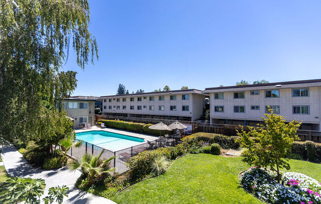 a backyard with a swimming pool and a building