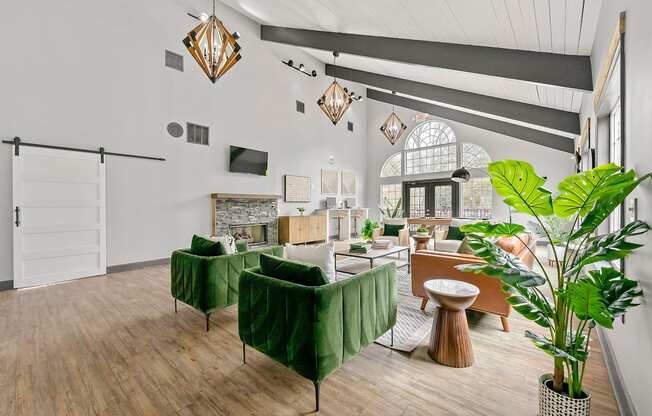A living room with a green sofa and a wooden floor.