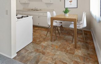 a kitchen with a table and chairs and a stove