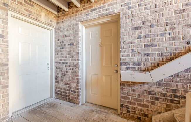 A white door is on the left and a beige door is on the right.