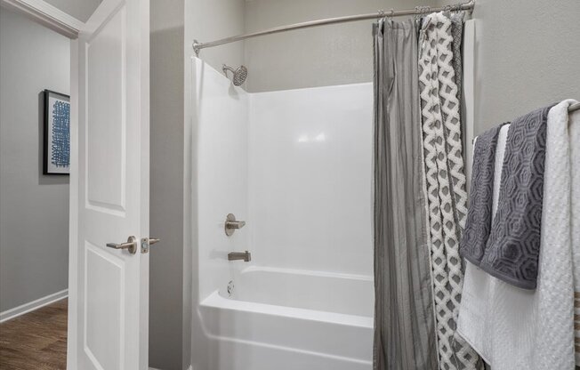 a bathroom with a tub and a shower with a curtain