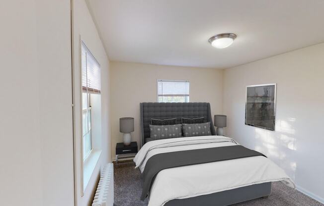 bedroom with bed, nightstand, windows and lighting at manor village apartments in washington dc