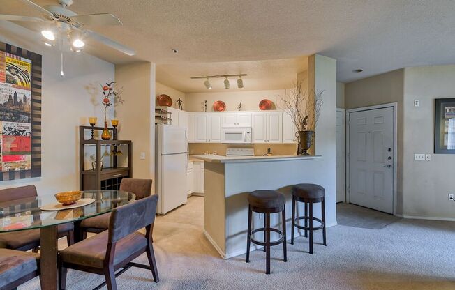 a kitchen with a bar and a dining table