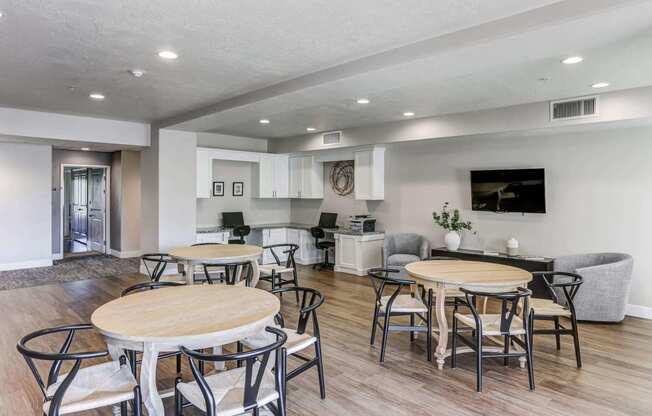 a common area with tables and chairs and a kitchen in the background at The Beckstead, Utah, 84095