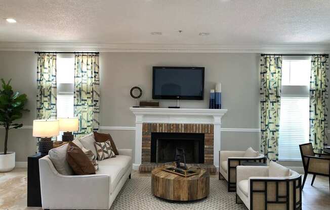 A living room with a fireplace and a television.