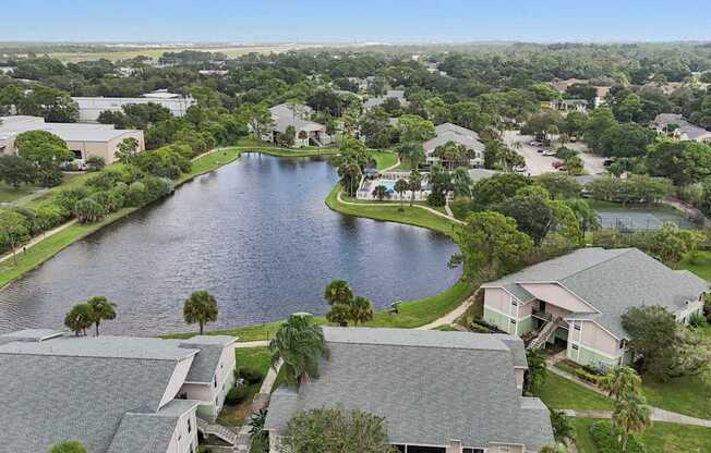A bird's eye view of a residential area with a large lake in the foreground.