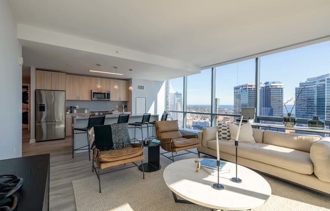 a living room with a view of the city and a couch and a table