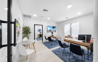 A living room with a couch and a table with chairs