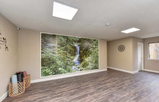 Community Yoga Studio with Hardwood Inspired Floor, Ceiling Lights, Large Window and Wicker Basket with Yoga Mats