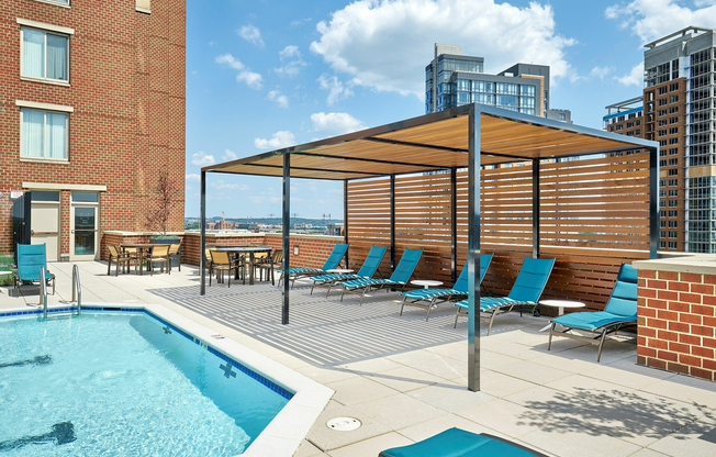 Soak up the sun at our newly renovated pool, featuring a shaded trellis, comfortable chaise lounges, and poolside dining tables.