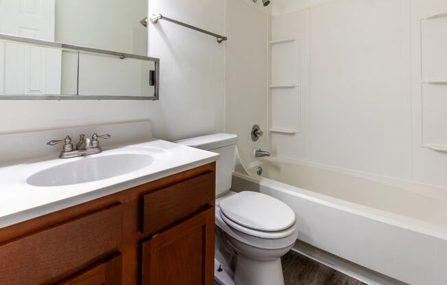 an empty bathroom with a sink toilet and bath tub