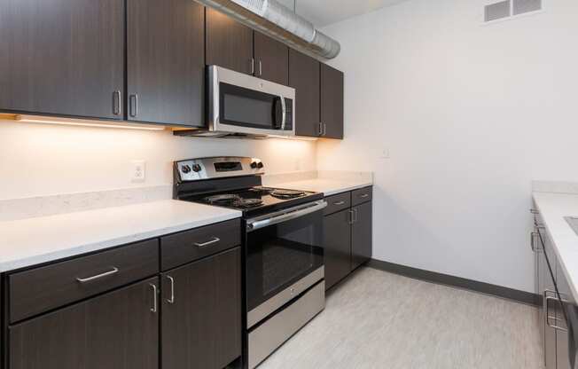 Modern open-concept kitchen and living area with stainless steel appliances.