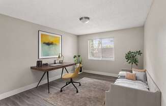 A room with a bed, desk, and chair.