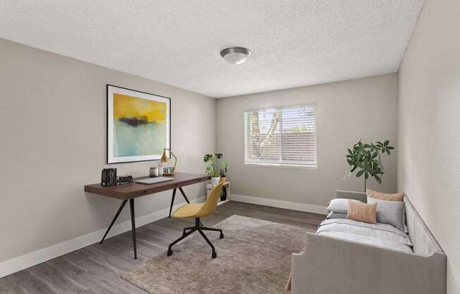 A room with a bed, desk, and chair.