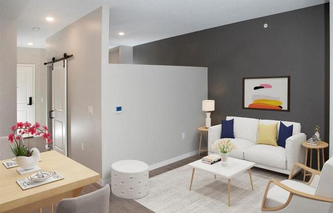 A modern living room with a white couch and a wooden coffee table.