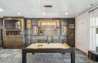 a game room with a pool table and a chandelier