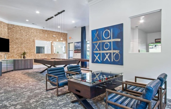 The residents lounge space with pool table and foosball at Adara Godley Station apartments in Savannah, GA.