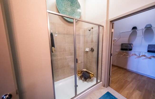 a shower with a glass door in a bathroom