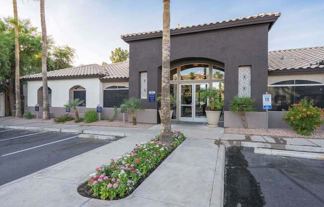 A building with a brown roof and a white wall with a door and windows at Sterling Point Apartment Homes, Phoenix, AZ, 85042