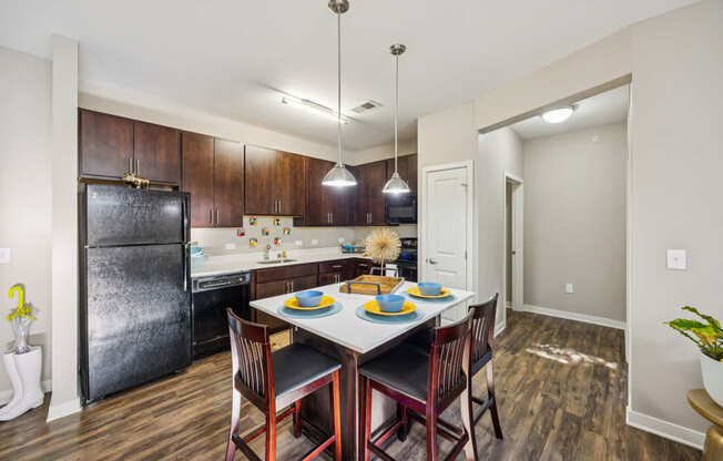 A kitchen with a table set for two.