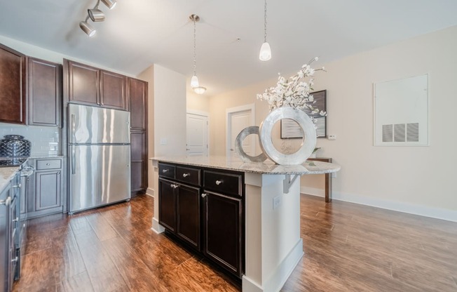 a kitchen with a large island and stainless steel appliances