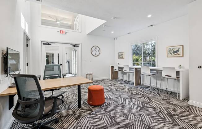 A room with a black chair and a patterned carpet.