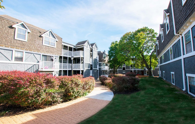 a pathway leading to an apartment complex