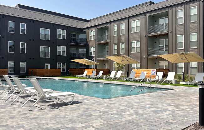 a swimming pool in front of an apartment building