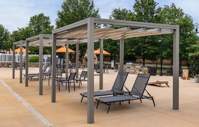 A patio with a canopy and chairs.