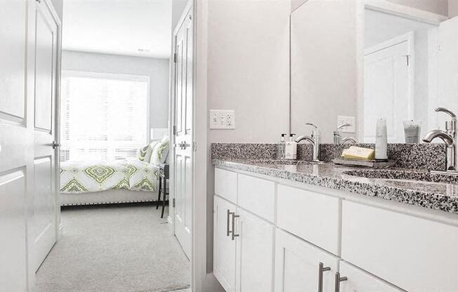 a white bathroom with a sink and a mirror