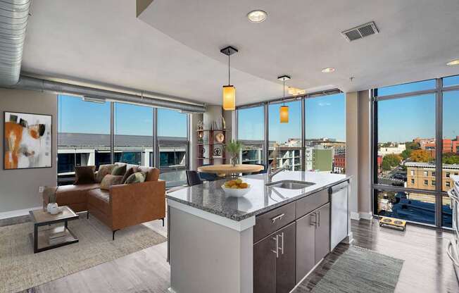 an open kitchen and living room with a view of the city