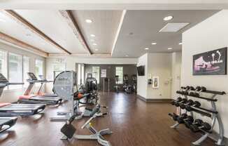 a spacious fitness center with treadmills and other exercise equipment