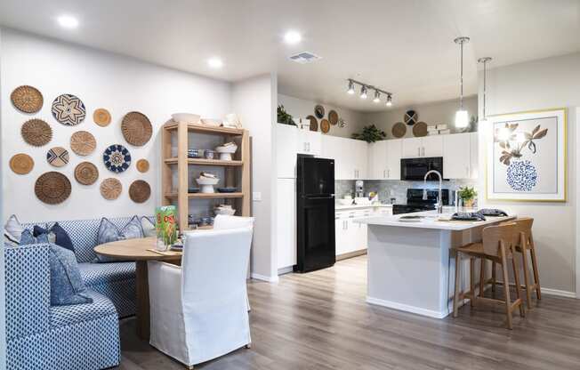 a living room and kitchen with a table and chairs