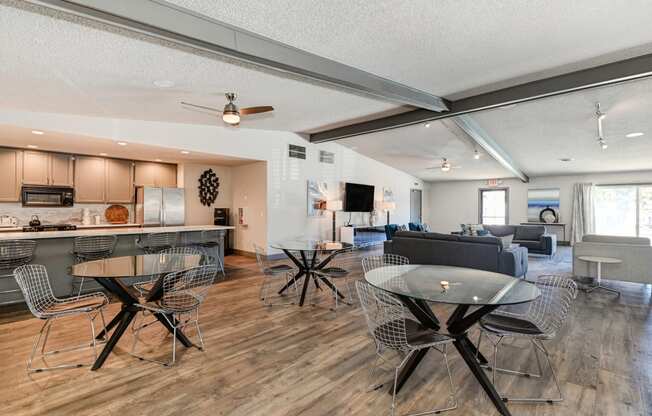 Community clubhouse with Hardwood Inspired Floors, and numerous seating areas and tables.