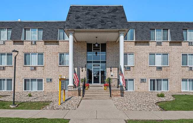 a brick building with two american flags in front of it