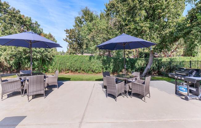 a table that has a umbrella in a park