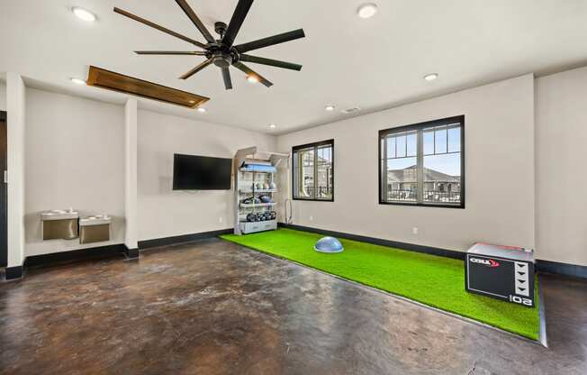 a room with a soccer ball on the floor and a tv on the wall