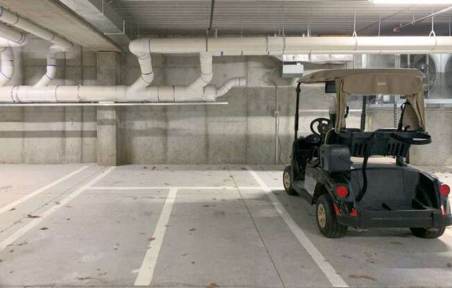 a golf cart parked in a dedicated space in the underground climate-controlled garage