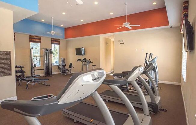 A gym with treadmills and exercise equipment.