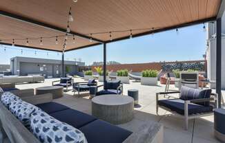 a roof top patio with couches and chairs and tables