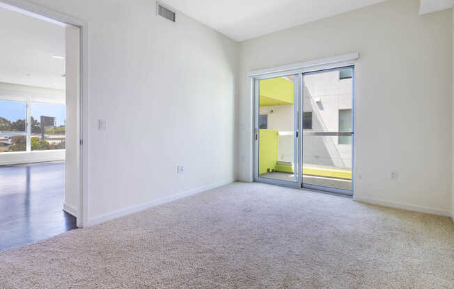 Carpeted Bedroom with Balcony